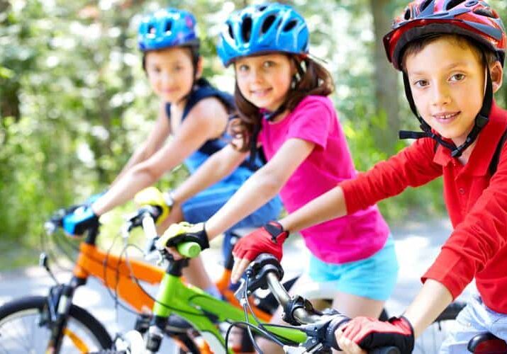 Children-riding-bikes-with-helmets Children-riding-bikes-with-helmets